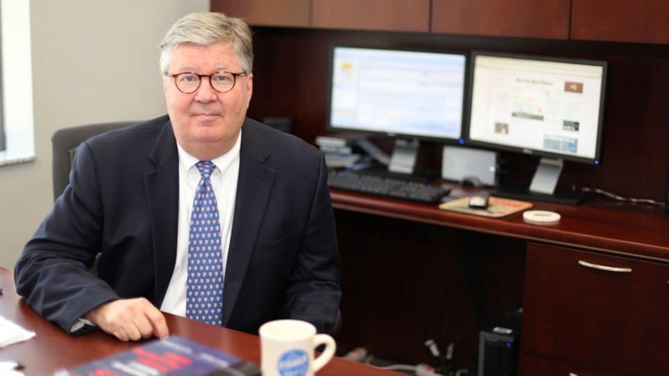 Gary McGill sitting at his desk