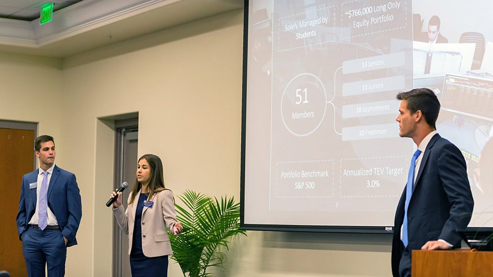 Three GSIF students give a presentation