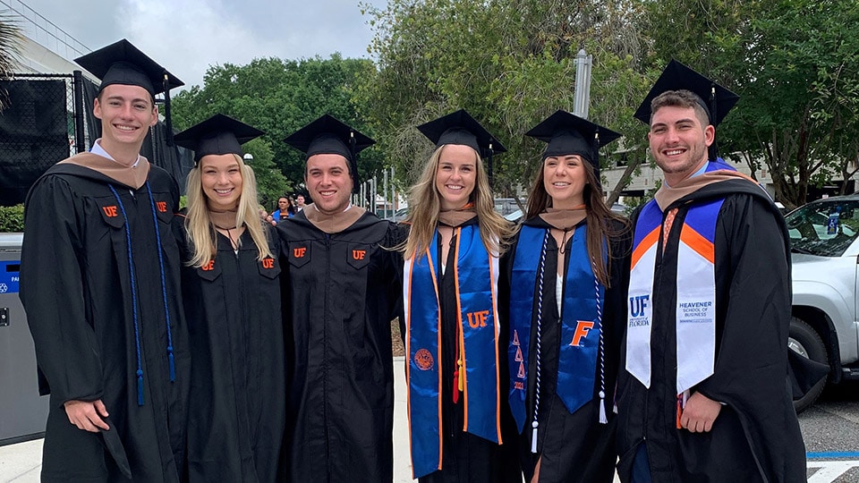 Six graduating students in their caps and gowns