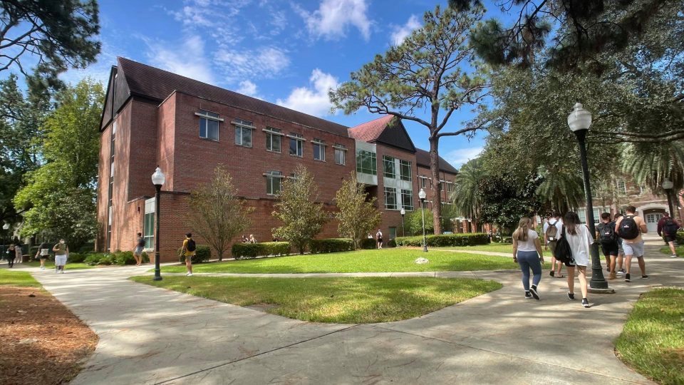 Students walking on sidewalks around Gerson Hall