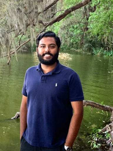 Haryshwa Murugappan stands at the edge of a Florida lake