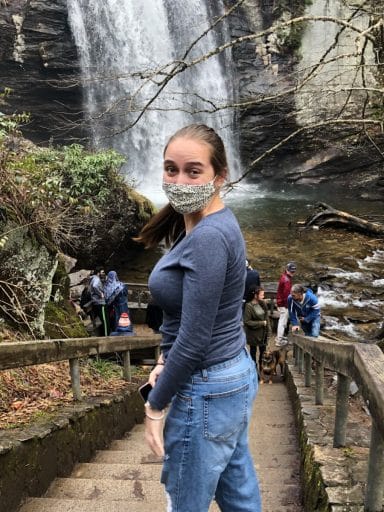 Tatiana Fabian walks down steps to see a waterfall