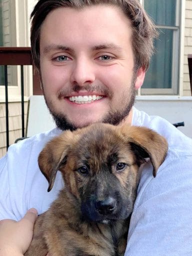 William Tompkins holds a puppy