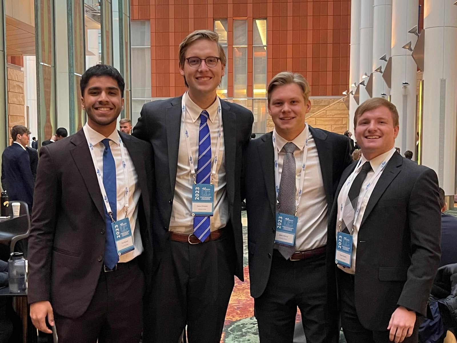 Four students at a stock competition