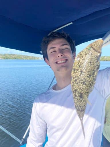 Kevin Tyler holds a fish up to the camera