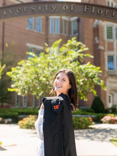 Madeleine MacLaren with the UF gateway and Heavener Hall in the background