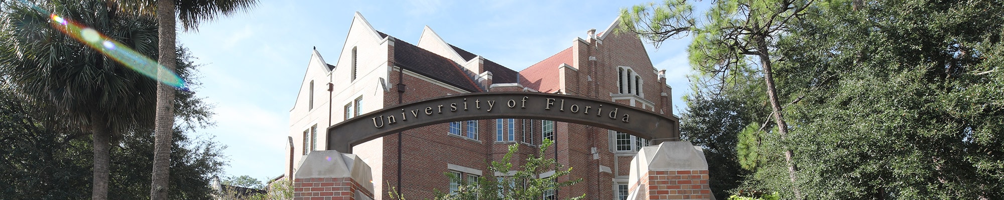 The University of Florida gateway on the corner of University Avenue and 13th Street with Heavener Hall in the background