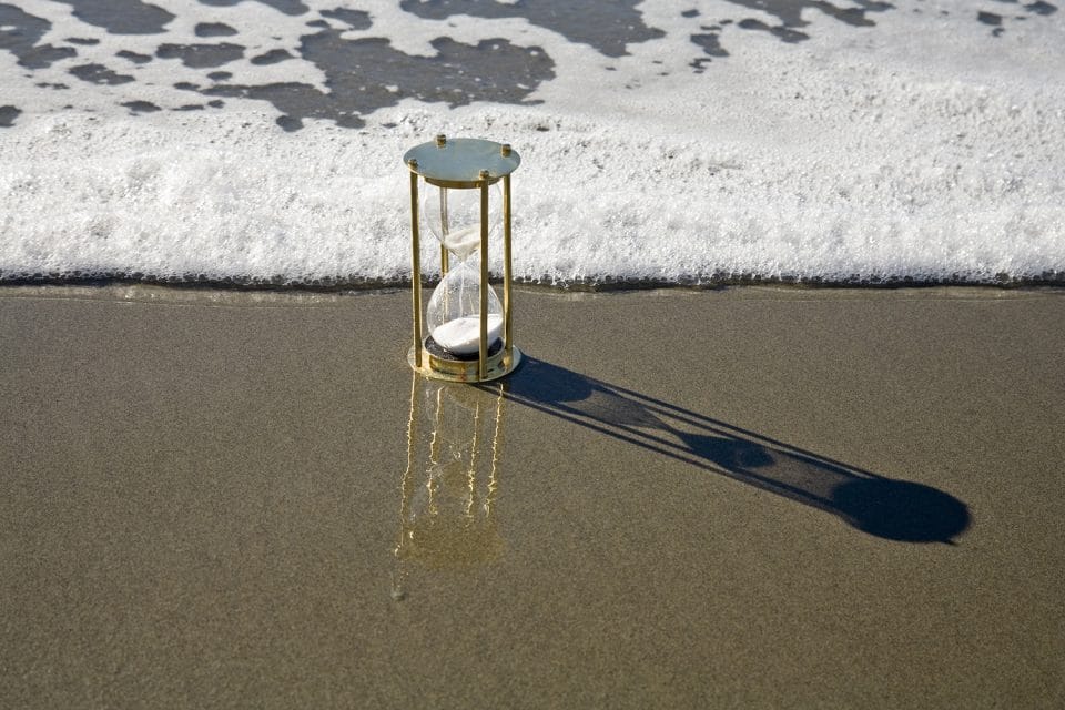 Hourglass on beach