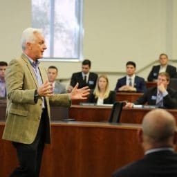 David Ling speaks to a classroom as students look on