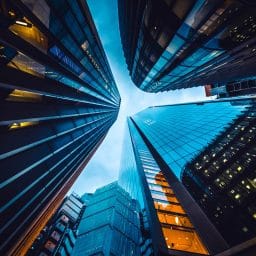 Looking skyward at the base of three tall buildings