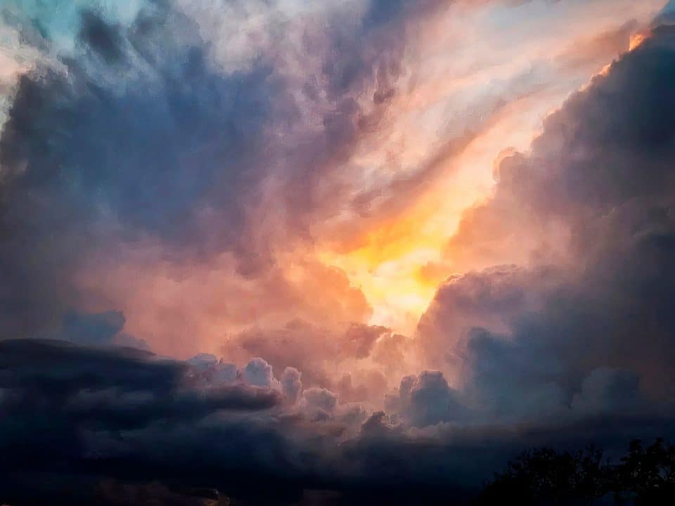 Painting of a cloudy sky with the sun trying to shine through creating some dramatic colors