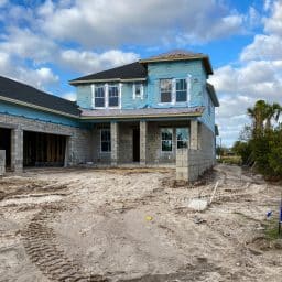 A house under construction with a sold sign out front