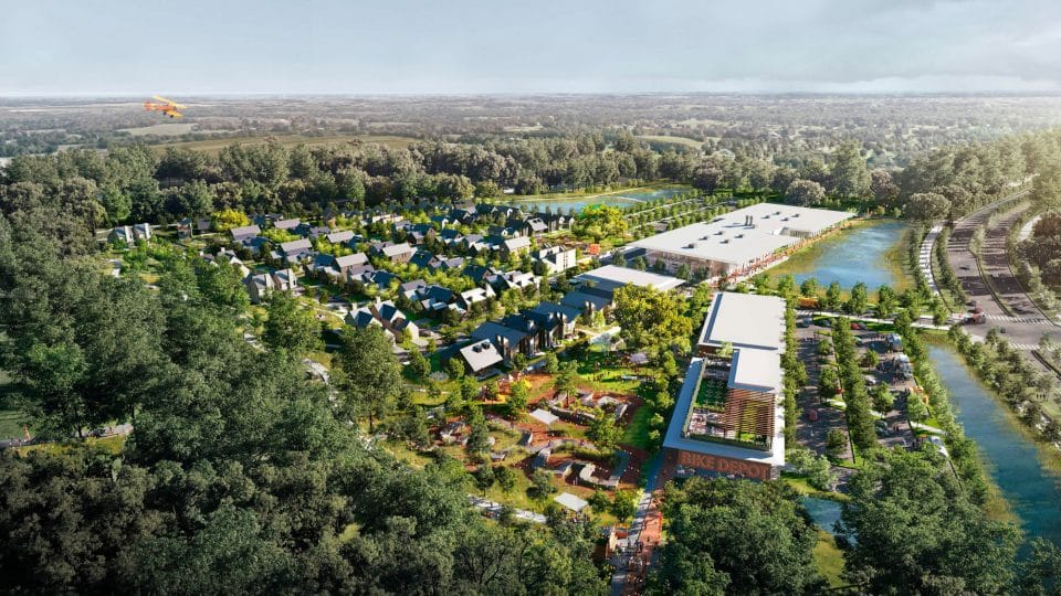 An aerial rendering of the Progress District in Alachua, Florida shows houses and businesses along a road and small, yellow airplane flying above