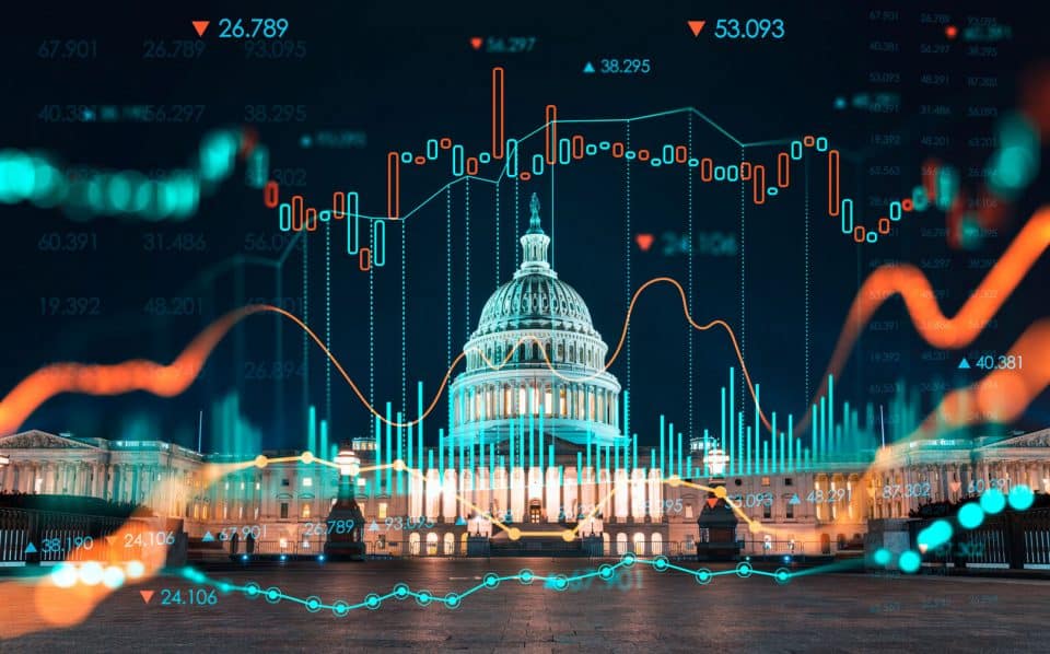 The U.S. Capitol building at night with chart lines and columns and numbers overlaid on top of it