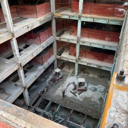 Looking down on construction equipment in the middle of a stripped out building