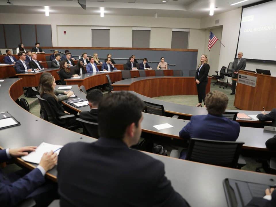 Anna Glass introduces speaker Peter Ma in a classroom for the Ring Speaker Series