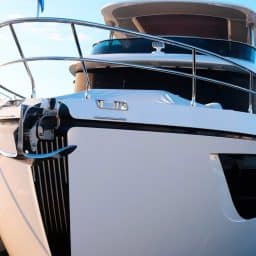 A docked boat in a marina with a blue sky