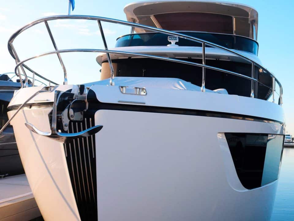 A docked boat in a marina with a blue sky