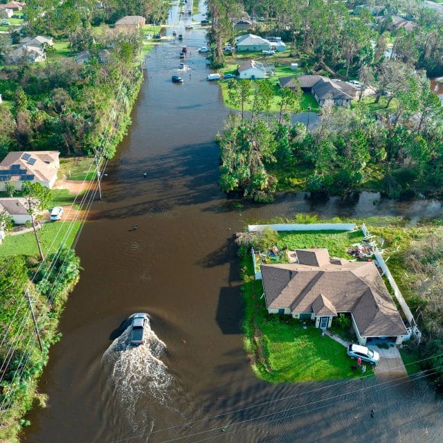 Aerial view of a flooded neighborhood as drivers attempt to navigate the streets