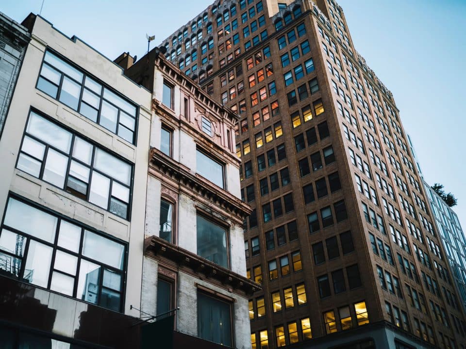 Looking up from street level at older tall buildings