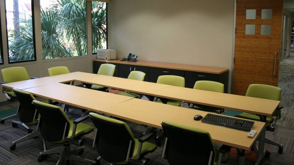 A room with a long table and chairs