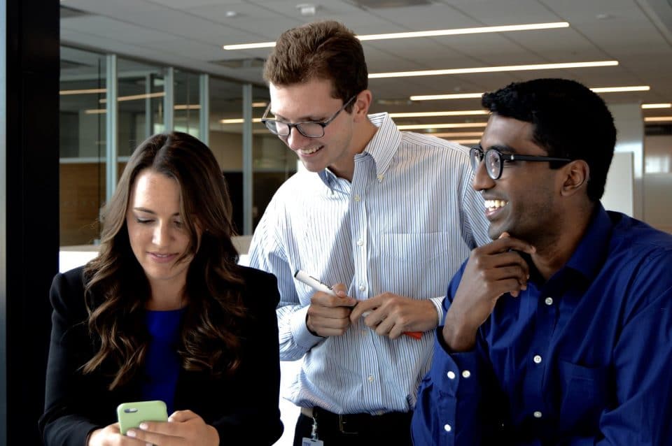 Three people working together in an office setting