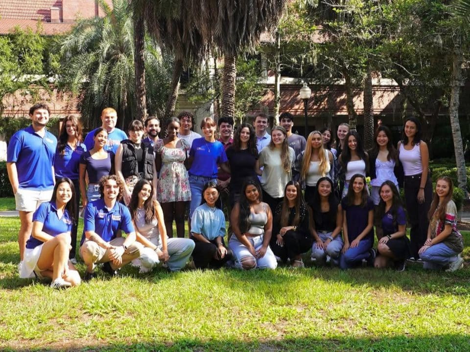 Group of student ambassadors with Bryan Hall in the background