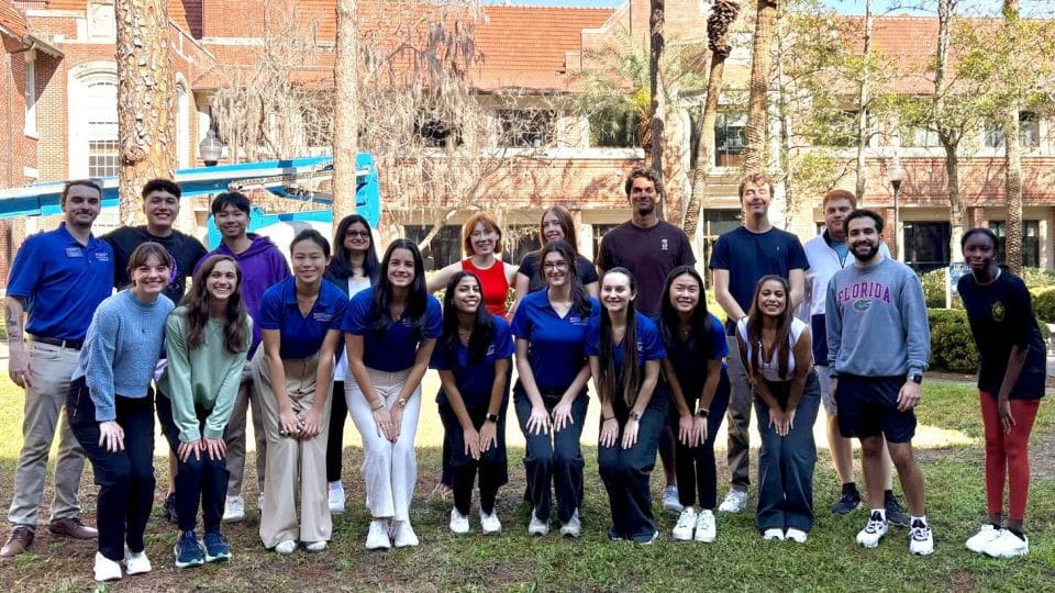 Group of student ambassadors with Bryan Hall in the background