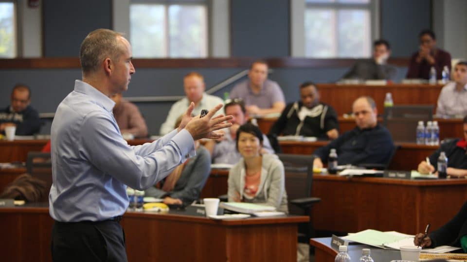 Sean Limon teaches class in Hough Hall while students look on