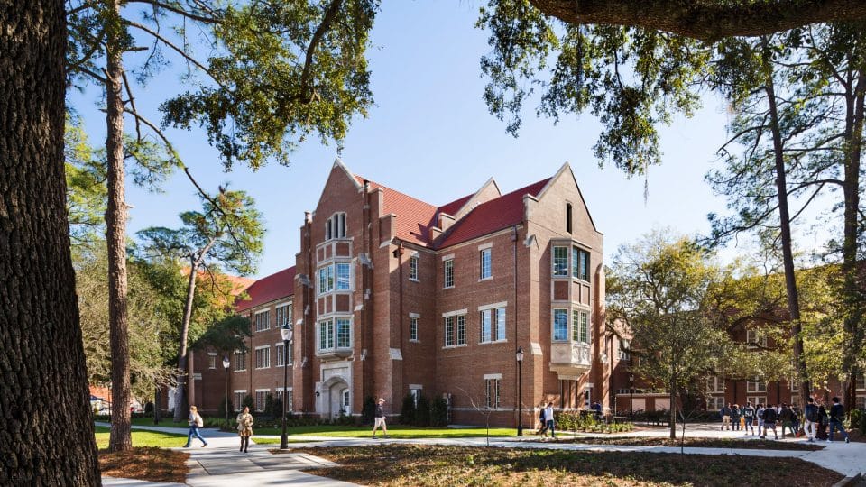 Heavener Hall with students walking by on a sunny day