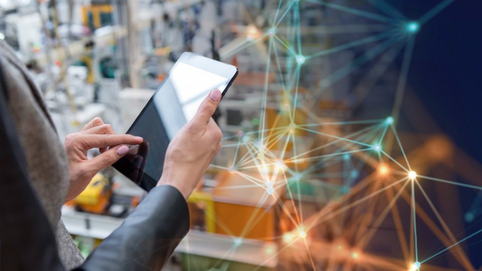 Woman using a tablet with production in the background