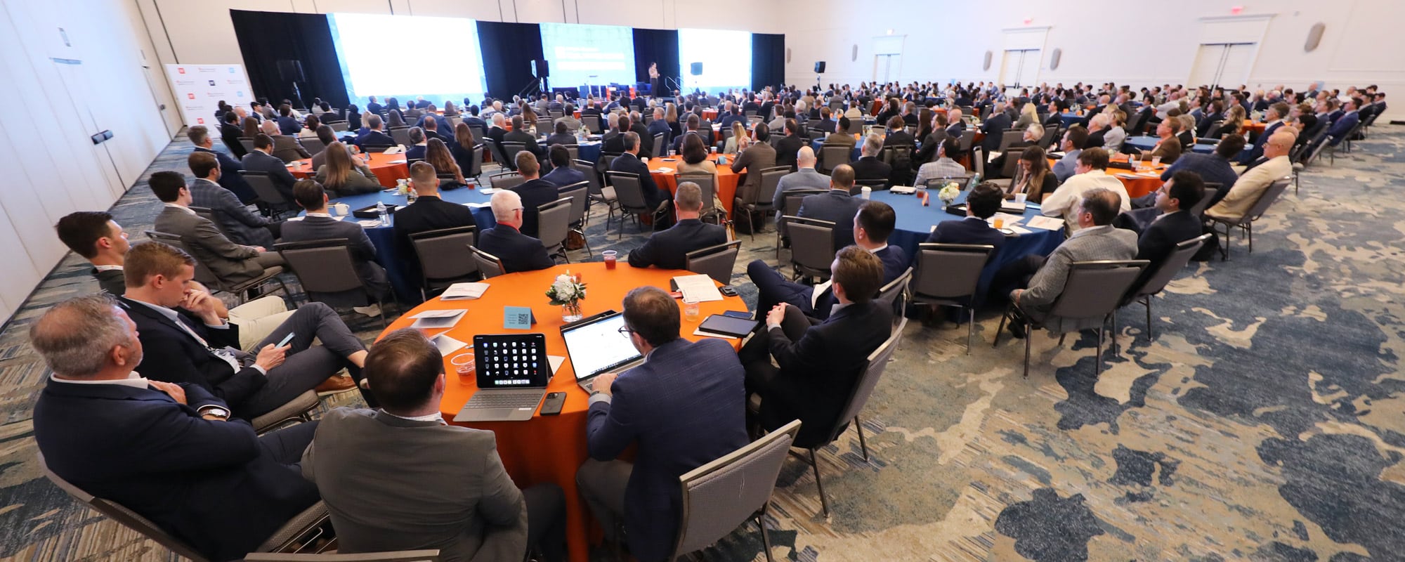 Trends Conference attendees in a large room listen to a speaker on stage