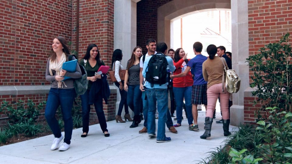 Heavener students between classes by Heavener Hall