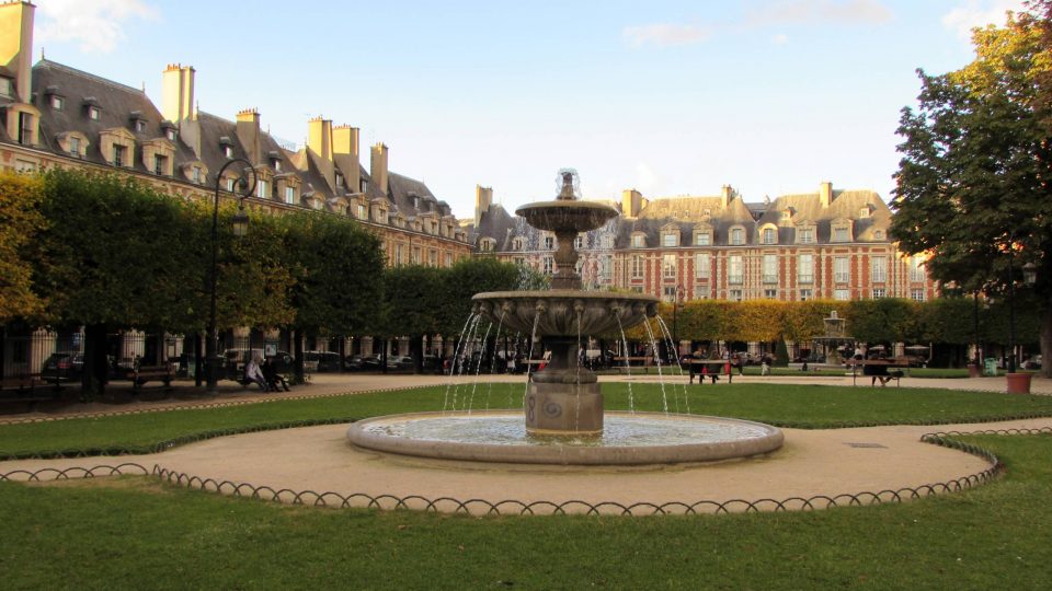 The fountain in Square Louis XIII in Paris, France