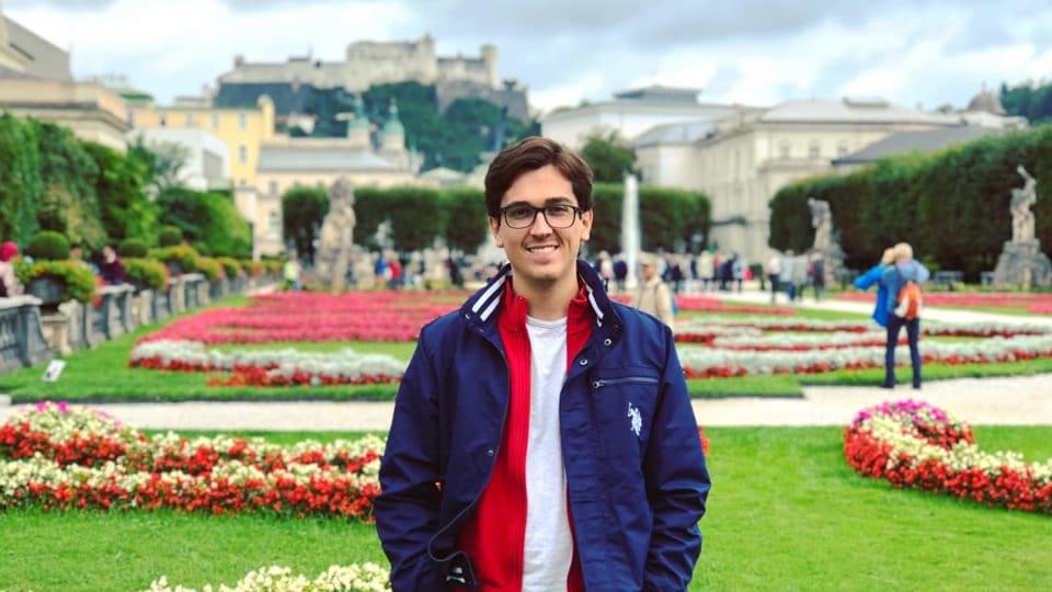 Student in front of Schloss Gardens in Austria.