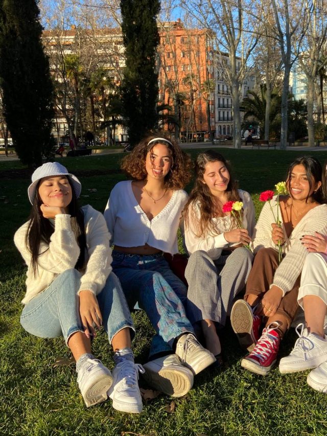 Student group relaxing in Templo de Debod Park in Madrid, Spain