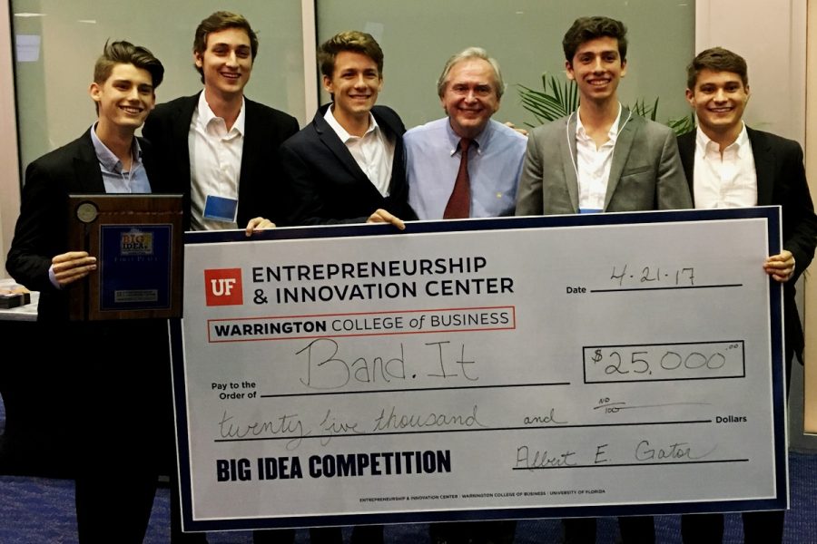 Winners of the 2017 Big Idea Competition, Band.It, hold the giant check for $25,000
