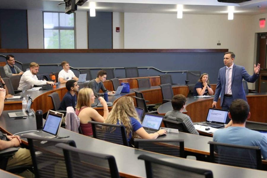 Professor Anthony Coman teaching a course in management communications to a small group of UF MBA Full-Time students