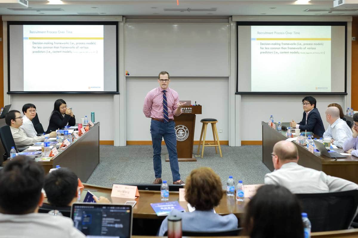 Brian Swider presents in front of a group of people. 