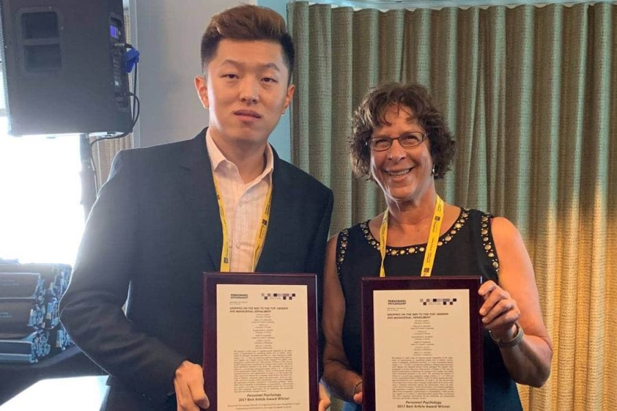 Yihao Liu and Joyce Bono hold their awards from Personnel Psychology