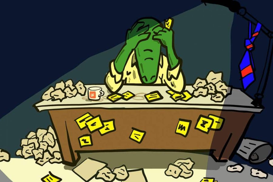 Cartoon gator sitting at a desk with lots of crumpled up papers looking down with his head in his hands