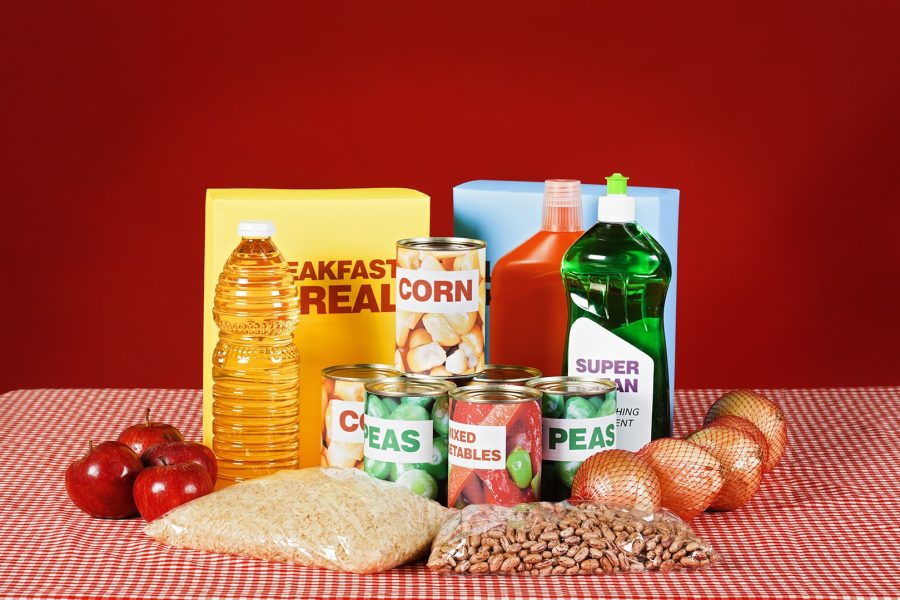 Generic food and cleaning products on gingham against red