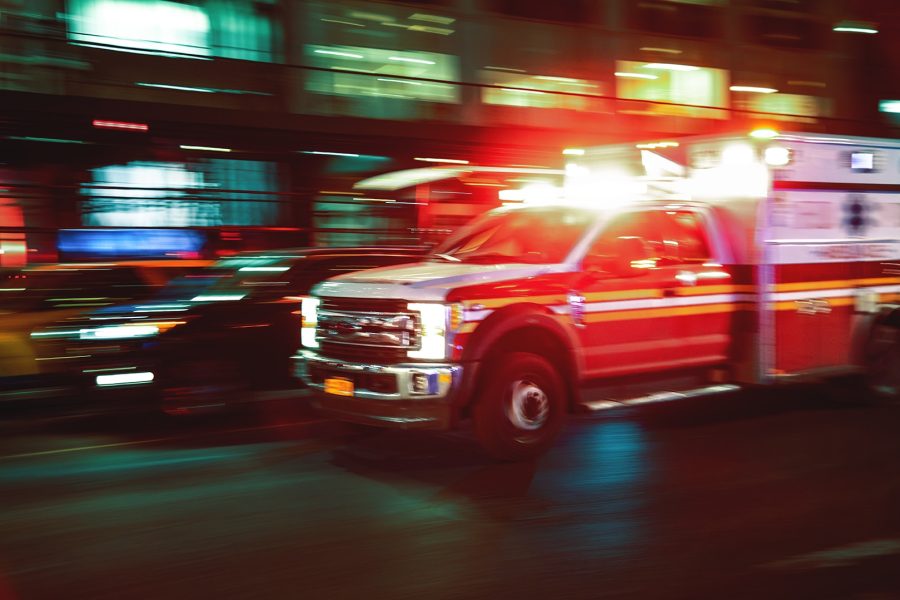 Motion blur ambulance on a street at night