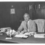 Robert Lanzillotti sits at his desk while serving as Dean of the Warrington College of Business