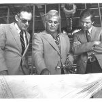 Hadley Schaefer, Robert Lanzillotti and John Simmons look down at plans for buildings on the Warrington College of Business campus