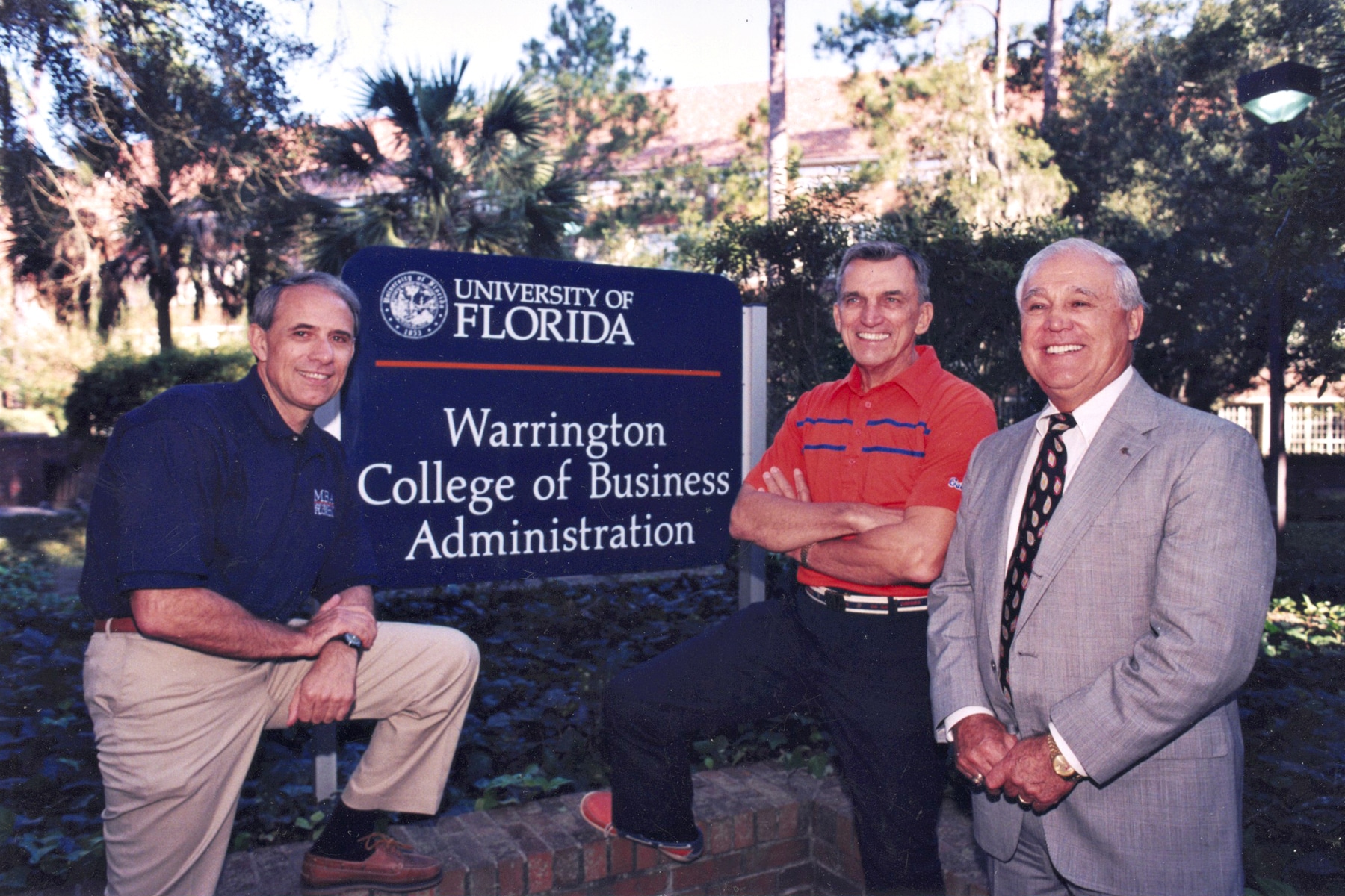 John Kraft, Al Warrington and Robert Lanzillotti pose for a photo in front of the Warrington College of Business sign.