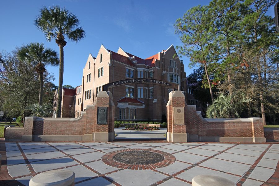 Heavener Hall in the background with the UF Archway and seal in the foreground.