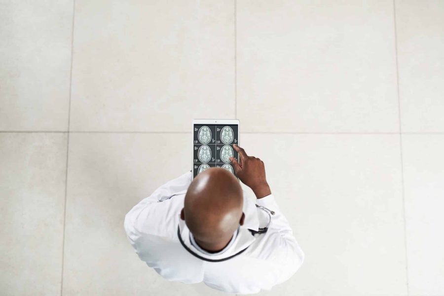 High angle of a doctor using a digital tablet to look at a brain scan