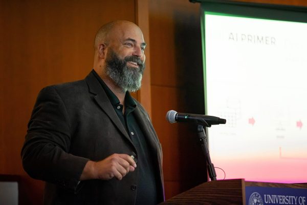 Joel Davis speaking at a podium at a conference