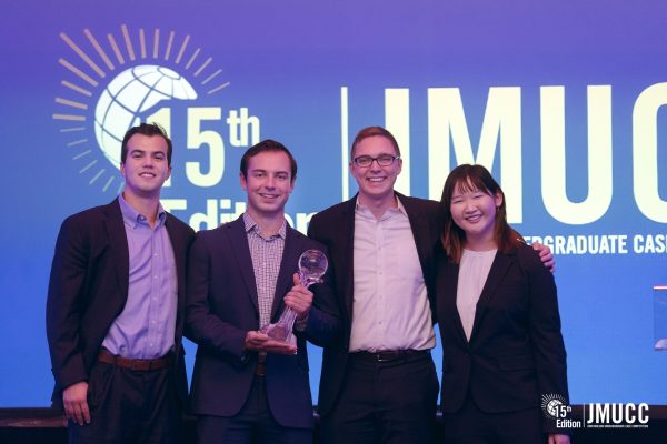 Four students holding first place trophy